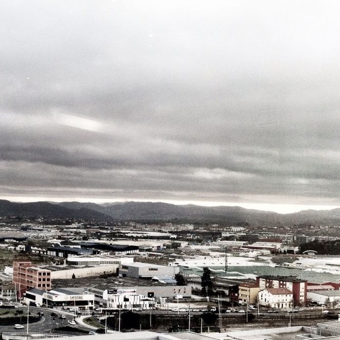 building exterior, architecture, built structure, sky, mountain, cloud - sky, city, cloudy, residential structure, house, residential building, weather, cityscape, residential district, high angle view, overcast, mountain range, cloud, town, townscape