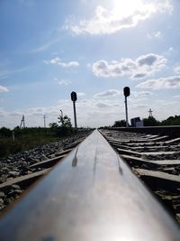 Surface level of railroad tracks against sky