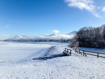 Scenic view of frozen lake against sky during winter