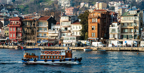 Boats in sea by buildings in city