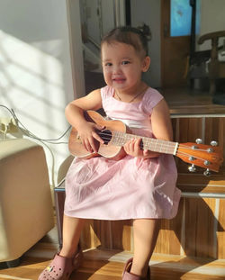 Little girl playing guitar