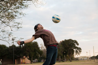 Man jumping to catch soccer ball