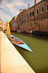 Boats in river with buildings in background