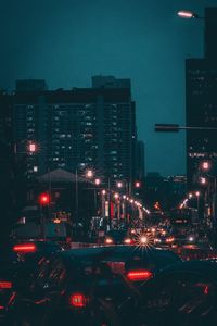 Illuminated city street and buildings at night