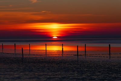 Scenic view of sea against orange sky
