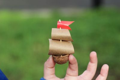 Cropped hand of child holding craft product