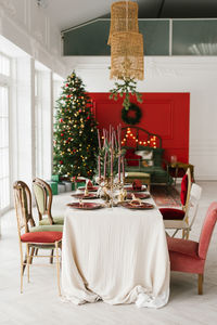 Elegant festive table set for christmas dinner in the interior of a classic living room