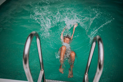 High angle view of man swimming in pool