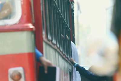 Cropped people boarding bus