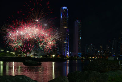 Firework display over river at night