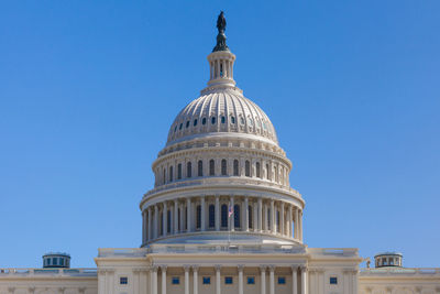 Low angle view of building against blue sky