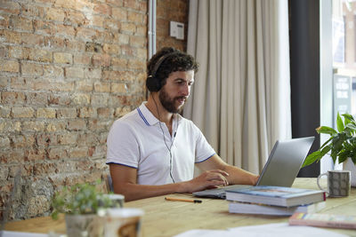 Businessman working using laptop and headphones. code programmer.