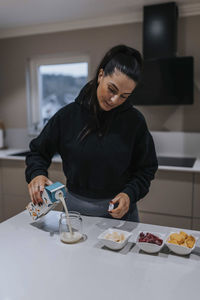 Woman preparing food in kitchen