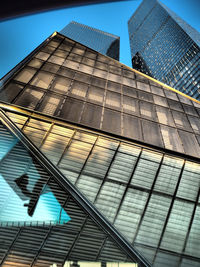 Low angle view of modern building against blue sky