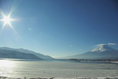 Scenic view of snowcapped mountain against cloudy sky