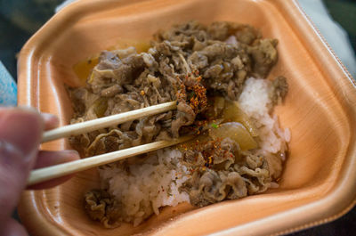 Close-up of hand holding bowl