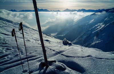 Ski poles on snowcapped mountain