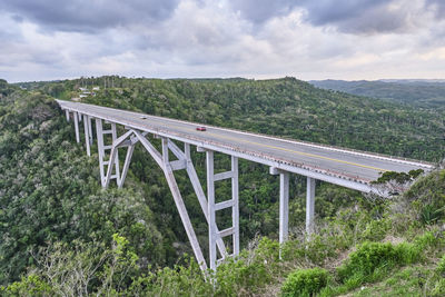 The highest of cuba bacunayagua bridge. automobile transport moving along bridge.