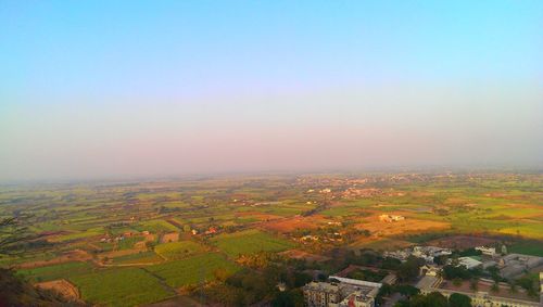 Aerial view of agricultural field against clear sky