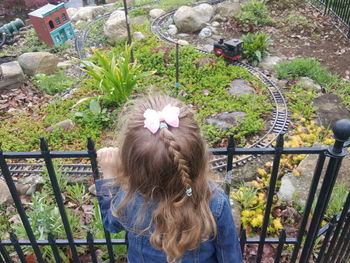 High angle view of girl looking at model at park