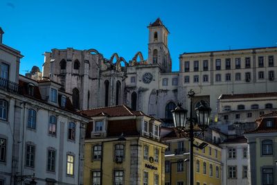 Low angle view of buildings against blue sky