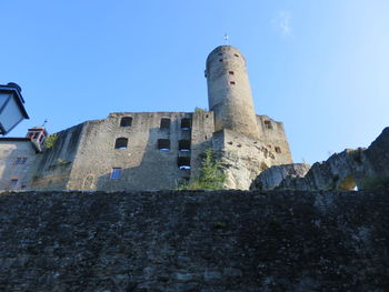 Low angle view of historic building against blue sky