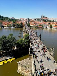 High angle view of people on charles bridge over vltava river in city
