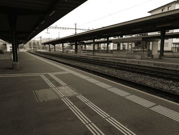 Empty railroad station against clear sky