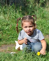 Cute baby girl holding plants