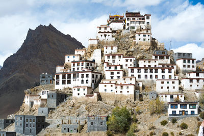 Buildings in front of old town against sky