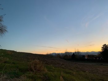 Scenic view of field against sky during sunset