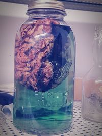 Close-up of ice cream in glass jar on table