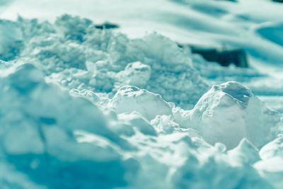 Close-up of snow on sea shore