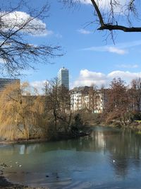 Scenic view of lake by buildings against sky