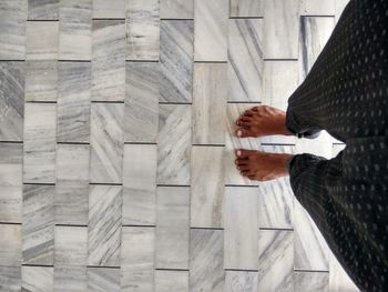 Man holding umbrella on wooden wall