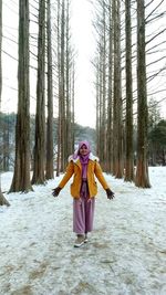 Woman standing on snow covered land