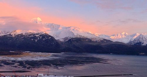 Scenic view of snowcapped mountains against sky during sunset