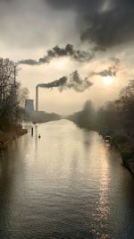 Scenic view of river against sky during sunset