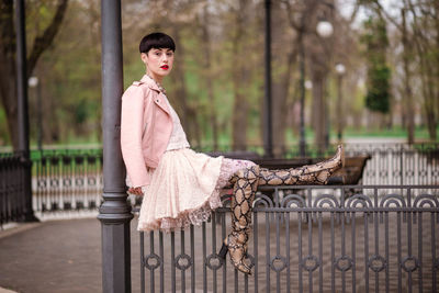 Portrait of a young woman sitting outdoors