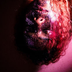 Close-up of human eye against black background