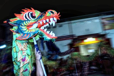 Multi colored sculpture of illuminated lighting equipment at night