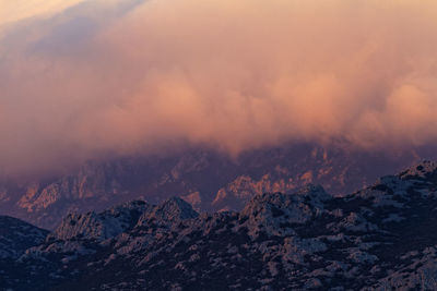 Scenic view of clouds above velebit  mountains against sky during sunset