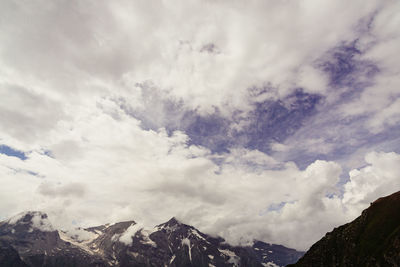 Low angle view of snowcapped mountains against sky