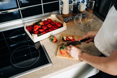 Midsection of man preparing food in kitchen at home