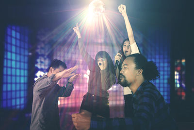 Young people at music concert at night