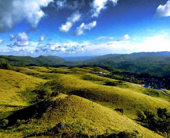 Scenic view of landscape against cloudy sky