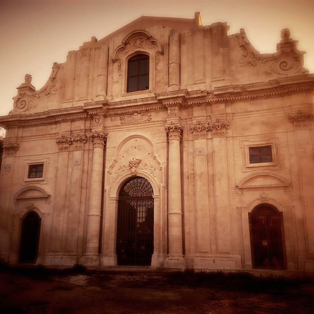 architecture, building exterior, built structure, church, religion, low angle view, arch, window, place of worship, facade, spirituality, sky, cathedral, old, outdoors, history, exterior, door