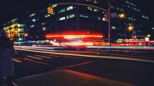 Light trails on road along buildings at night