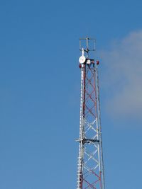 Low angle view of wind turbine against clear blue sky