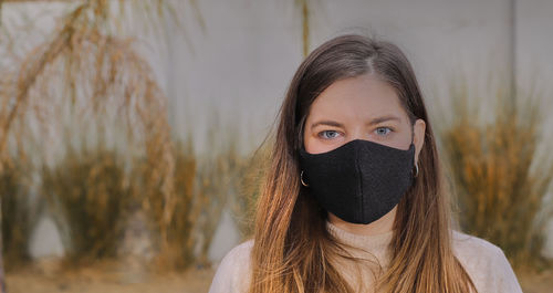 Portrait of beautiful woman covering face